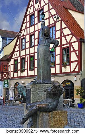 "Statues wearing gloves on the Gauklerbrunnen well by artist Harro Frey, an old half-timbered house at the back, Gruener Markt square, historic district, Marktplatz, Altstadt, Fuerth, Middle Franconia, Bavaria, Germany, Europe" View Large Photo Image Stock Photography - "Statues wearing gloves on the Gauklerbrunnen well by artist Harro Frey, an old half-timbered house at the back, Gruener Markt square, historic district, Marktplatz, Altstadt, Fuerth, Middle Franconia, Bavaria, Germany, Europe". Fotosearch