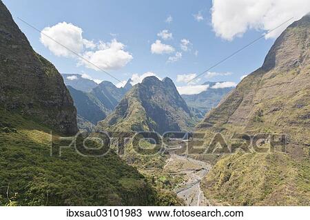 Stock Image - "Steep mountains, mountain valley with the Riviere des Galets river, Reunion". Fotosearch