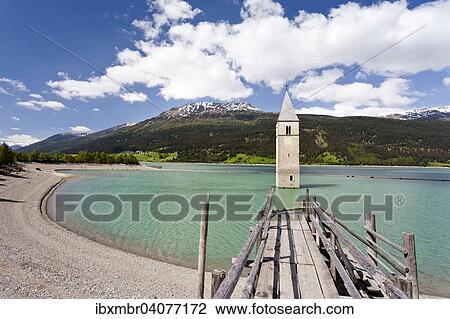 "Steeple of Alt-Graun in Lake Reschensee in Alta Val Venosta, feservoir, Graun im Vinschgau, South Tyrol Province of region of Trentino-Alto Adige, Italy, Europe" View Large Photo Image Stock Image - "Steeple of Alt-Graun in Lake Reschensee in Alta Val Venosta, feservoir, Graun im Vinschgau, South Tyrol Province of region of Trentino-Alto Adige, Italy, Europe". Fotosearch