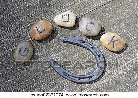 "Stones with letters forming the word """"Glueck"""", German for """"luck"""", and a horseshoe" View Large Photo Image Picture - "Stones with letters forming the word """"Glueck"""", German for """"luck"""", and a horseshoe". Fotosearch