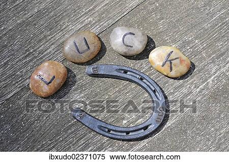 "Stones with letters forming the word """"Glueck"""", German for """"luck"""", and a horseshoe" View Large Photo Image Stock Photography - "Stones with letters forming the word """"Glueck"""", German for """"luck"""", and a horseshoe". Fotosearch