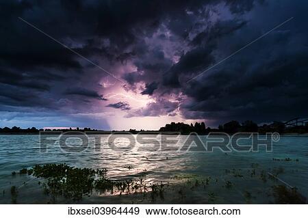 "Storm clouds over a quarry lake with water plants, near Mindelheim, Unterallgau, Allgau, Bavaria, Germany, Europe" View Large Photo Image Stock Photo - "Storm clouds over a quarry lake with water plants, near Mindelheim, Unterallgau, Allgau, Bavaria, Germany, Europe". Fotosearch