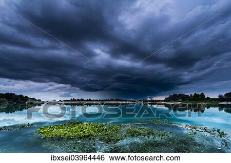 "Storm clouds over a quarry lake with water plants, near Mindelheim, Unterallgau, Allgau, Bavaria, Germany, Europe" View Large Photo Image Stock Photograph - "Storm clouds over a quarry lake with water plants, near Mindelheim, Unterallgau, Allgau, Bavaria, Germany, Europe". Fotosearch