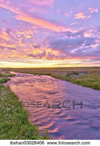 Stock Photograph - "Stream in the afterglow of the sunset, Iceland, Europe". Fotosearch