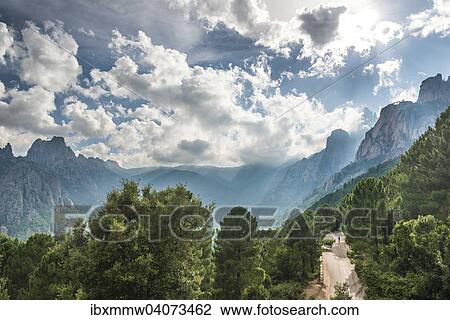 "Street through a valley with cliffs in clouds, Col de Bavella, Bavella Massif, Corsica, France, Europe" View Large Photo Image Stock Image - "Street through a valley with cliffs in clouds, Col de Bavella, Bavella Massif, Corsica, France, Europe". Fotosearch