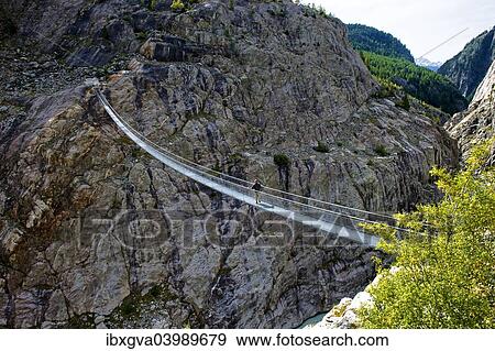 Stock Photo - "Stressed-ribbon bridge across Massa Gorge, Belalp tourism region, Canton of Valais, Switzerland, Europe". Fotosearch