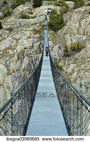 "Stressed-ribbon bridge across Massa Gorge, Belalp tourism region, Canton of Valais, Switzerland, Europe" View Large Photo Image Stock Photography - "Stressed-ribbon bridge across Massa Gorge, Belalp tourism region, Canton of Valais, Switzerland, Europe". Fotosearch
