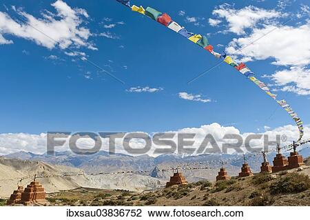 "Stupas and prayer flags, chortens in a row in a mountain landscape, Ghar Gompa Monastery, Lo Gekar, Upper Mustang, Lo, Himalayas, Nepal, Asia" View Large Photo Image Stock Image - "Stupas and prayer flags, chortens in a row in a mountain landscape, Ghar Gompa Monastery, Lo Gekar, Upper Mustang, Lo, Himalayas, Nepal, Asia". Fotosearch