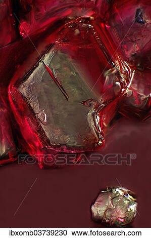Stock Image - "Sugar crystal, ordinary table sugar dissolves in cherry juice, photomicrography". Fotosearch
