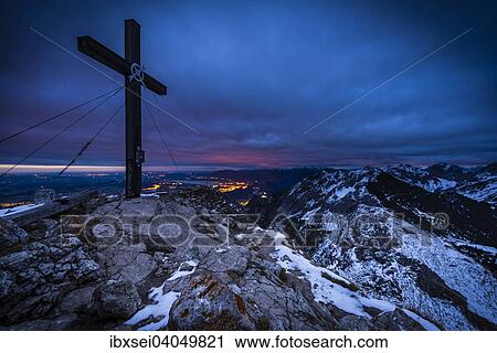 Stock Image - "Summit cross of Mt Aggenstein at dusk, blue hour, Gran, Tannheim Valley, Tyrol, Austria, Europe". Fotosearch