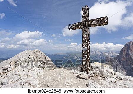 Stock Photograph - "Summit cross on Plattkofel Mountain, looking towards the Odle Mountain Group, Dolomites, Alto Adige, Italy, Europe". Fotosearch