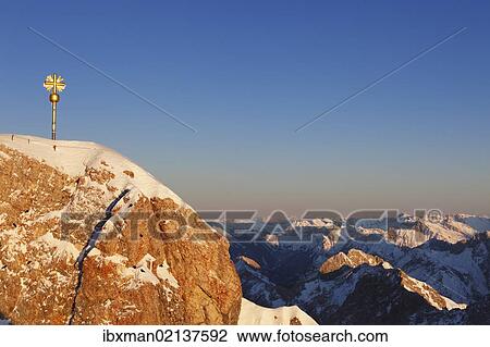 "Summit cross on Zugspitze Mountain in the evening light, looking towards the east, Wetterstein Mountains, Upper Bavaria, Bavaria, Germany, Europe" View Large Photo Image Stock Image - "Summit cross on Zugspitze Mountain in the evening light, looking towards the east, Wetterstein Mountains, Upper Bavaria, Bavaria, Germany, Europe". Fotosearch