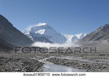 Stock Image - "Summit of Mount Everest, light fog, Base Camp north side, glacial river, the Himalayas, central Tibet, U-Tsang, Tibet Autonomous Region, People's Republic of China, Asia". Fotosearch