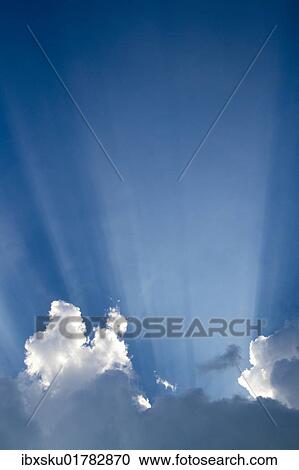 Sun rays behind clouds View Large Photo Image Stock Image - Sun rays behind clouds. Fotosearch