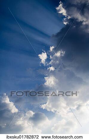 Sun rays behind clouds View Large Photo Image Stock Image - Sun rays behind clouds. Fotosearch