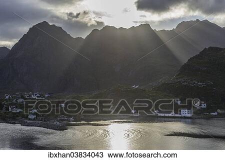 "Sun rays breaking through the clouds over the mountains of the municipality of Moskenes, Lofoten, Nordland, Norway, Europe" View Large Photo Image Stock Image - "Sun rays breaking through the clouds over the mountains of the municipality of Moskenes, Lofoten, Nordland, Norway, Europe". Fotosearch