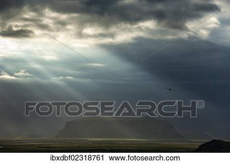 "Sun rays shining through clouds, moody lighting, South Coast, Iceland, Europe" View Large Photo Image Stock Image - "Sun rays shining through clouds, moody lighting, South Coast, Iceland, Europe". Fotosearch