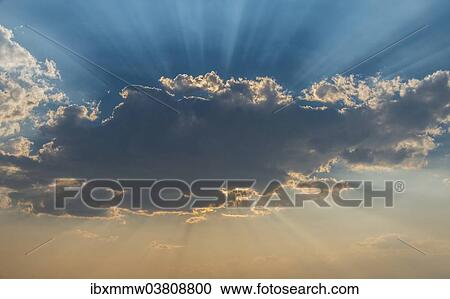 Stock Image - "Sun shining behind a cloud, Etosha National Park, Namibia, Africa". Fotosearch