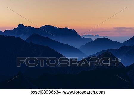 Picture - "Sunrise above the Allgau Alps with peaks in steplike arrangement, Oberstdorf, Bavaria, Germany, Europe". Fotosearch