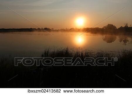 "Sunrise, autumn fog over Big Rock Lake near Detroit Lakes, Minnesota, USA" View Large Photo Image Stock Image - "Sunrise, autumn fog over Big Rock Lake near Detroit Lakes, Minnesota, USA". Fotosearch
