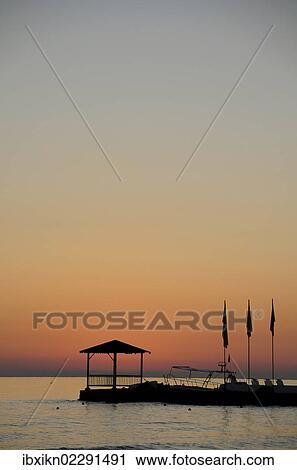 Stock Image - "Sunrise, Cretan Sea, Stalida, Stalis, Crete, Greece, Europe". Fotosearch