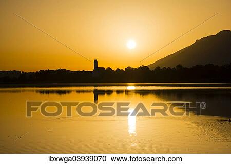 "Sunrise, Forggensee Lake, municipality of Waltenhofen at the back, Ostallgau, Allgau, Swabia, Bavaria, Germany, Europe" View Large Photo Image Stock Image - "Sunrise, Forggensee Lake, municipality of Waltenhofen at the back, Ostallgau, Allgau, Swabia, Bavaria, Germany, Europe". Fotosearch