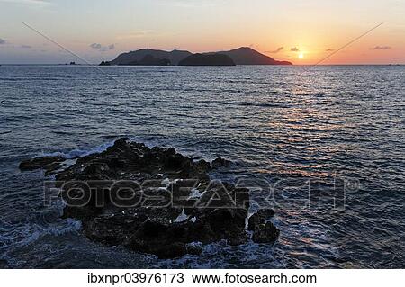 "Sunrise next to small island in the sea, rocks, Tyrrel's Bay, Little Tobago, Trinidad and Tobago, North America" View Large Photo Image Stock Image - "Sunrise next to small island in the sea, rocks, Tyrrel's Bay, Little Tobago, Trinidad and Tobago, North America". Fotosearch