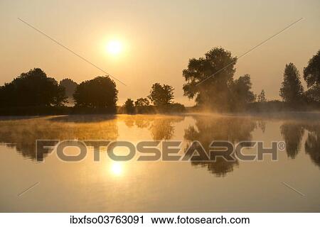 "Sunrise over a pond landscape, Herbsleben, Thuringia, Germany, Europe" View Large Photo Image Stock Image - "Sunrise over a pond landscape, Herbsleben, Thuringia, Germany, Europe". Fotosearch