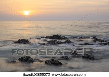 Stock Image - "Sunrise over the Arabian Sea, Masirah or Mazeira Island, Oman, Asia". Fotosearch