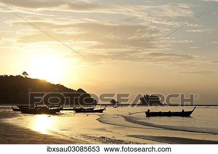 "Sunset at the beach, fishing boats in silhouette, Nai Yang Beach, Phuket, Phuket Province, Thailand, Asia" View Large Photo Image Stock Image - "Sunset at the beach, fishing boats in silhouette, Nai Yang Beach, Phuket, Phuket Province, Thailand, Asia". Fotosearch