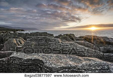 Stock Photo - "Sunset at the Pancake Rocks, Paparoa National Park, Punakaiki, South Island, New Zealand, Oceania". Fotosearch