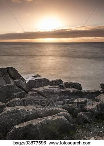 Stock Photograph - "Sunset at the Pancake Rocks, Paparoa National Park, Punakaiki, South Island, New Zealand, Oceania". Fotosearch