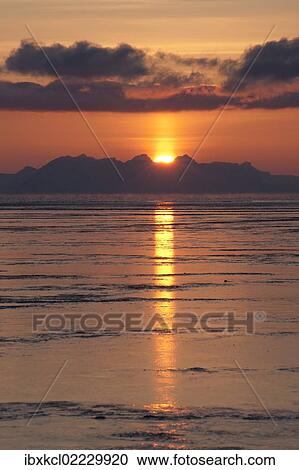"Sunset behind the mountains of the Isfjorden with reflections in the tidal flats, Longyearbyen, Spitsbergen, Svalbard, Norway, Europe" View Large Photo Image Stock Image - "Sunset behind the mountains of the Isfjorden with reflections in the tidal flats, Longyearbyen, Spitsbergen, Svalbard, Norway, Europe". Fotosearch