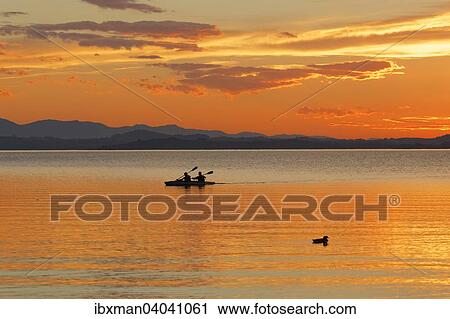 Stock Image - "Sunset on Lake Chiemsee in Chieming, Chiemgau, Upper Bavaria, Bavaria, Germany, Europe". Fotosearch