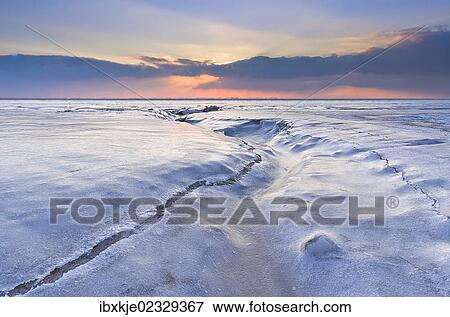 Stock Photo - "Sunset on the frozen North Sea, Lower Saxony, Germany, Europe". Fotosearch