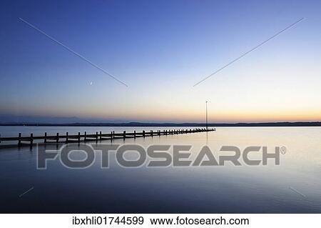 Stock Photo - "Sunset over Lake Starnberg, dock near Ambach, Muensing municipality, Bavaria, Germany, Europe". Fotosearch