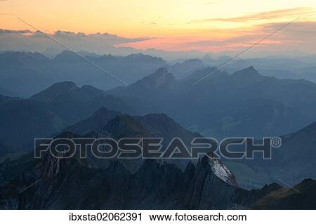 Stock Image - "Sunset overlooking the Swiss Alps in eastern Switzerland, from Mt Saentis in the Alpstein Range, Switzerland, Europe". Fotosearch