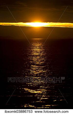 Stock Image - "Sunset reflected in sea, Hinlopenstretet, Svalbard Archipelago, Svalbard and Jan Mayen, Norway, Europe". Fotosearch