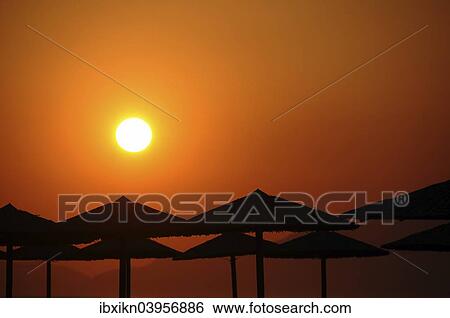 "Sunset, sun shades, silhouettes, Tigaki, Greece, Europe" View Large Photo Image Stock Photograph - "Sunset, sun shades, silhouettes, Tigaki, Greece, Europe". Fotosearch