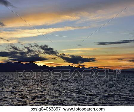 "Sunset with clouds at Lake Chiemsee in Chieming, foothills of the Alps, Chiemgau, Bavaria, Germany, Europe" View Large Photo Image Stock Photo - "Sunset with clouds at Lake Chiemsee in Chieming, foothills of the Alps, Chiemgau, Bavaria, Germany, Europe". Fotosearch