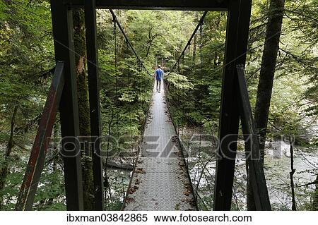 Stock Photography - "Suspension bridge across the Subersbach creek, built in 1901, Egg, Lingenau, Bregenz Forest, Vorarlberg, Austria, Europe". Fotosearch