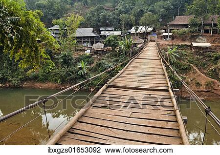 Stock Image - "Suspension bridge leading to a village, Mai Chau valley, Northern Vietnam, Vietnam, Asia". Fotosearch