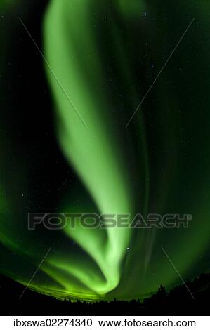 Stock Image - "Swirling northern polar lights, Aurora Borealis, green, near Whitehorse, Yukon Territory, Canada, North America". Fotosearch