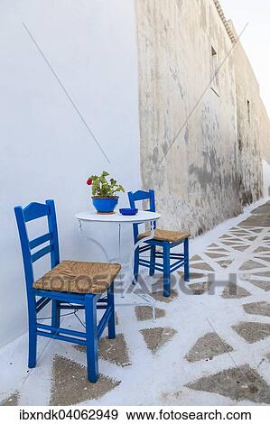 "Table and chairs in an alley, Arkasa, Karpathos, Dodecanese, South Aegean, Greece, Europe" View Large Photo Image Stock Photo - "Table and chairs in an alley, Arkasa, Karpathos, Dodecanese, South Aegean, Greece, Europe". Fotosearch