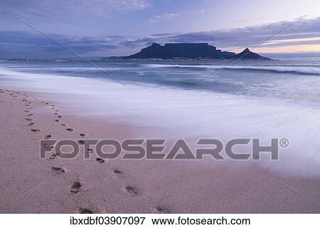 Stock Photo - "Table Mountain, Lion's Head and Devil's Peak in the evening light, panoramic view of Cape Town, footprints on Bloubergstrand beach, Table Bay in the Atlantic Ocean, Cape Town, Western Cape, South Africa, Africa". Fotosearch