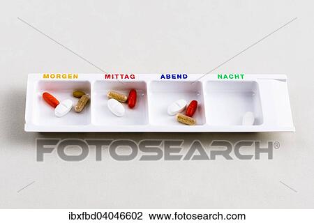 "Tablet dispenser filled with pills for the whole day, labelled in German" View Large Photo Image Stock Image - "Tablet dispenser filled with pills for the whole day, labelled in German". Fotosearch