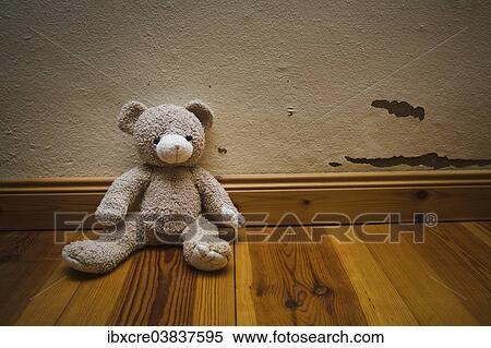 Teddy bear sitting on a wooden floor View Large Photo Image Stock Photography - Teddy bear sitting on a wooden floor. Fotosearch