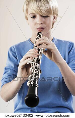 Stock Image - Teenage boy playing the oboe. Fotosearch