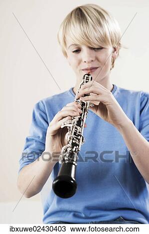 Teenage boy playing the oboe View Large Photo Image Stock Image - Teenage boy playing the oboe. Fotosearch
