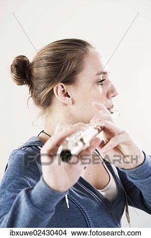 Teenage girl playing the flute View Large Photo Image Picture - Teenage girl playing the flute. Fotosearch